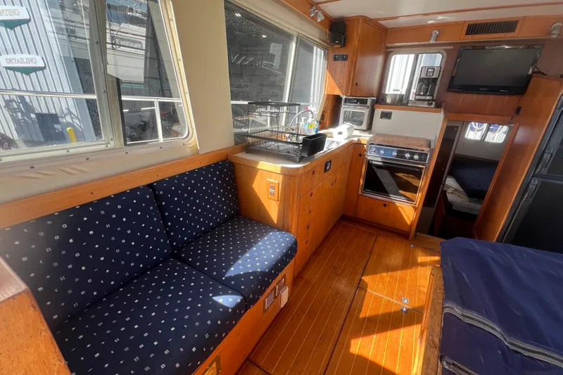 Slide: The Image of Interior of 1990 Sabreline 36 Fast Trawler with wood finish and blue seating. - 4