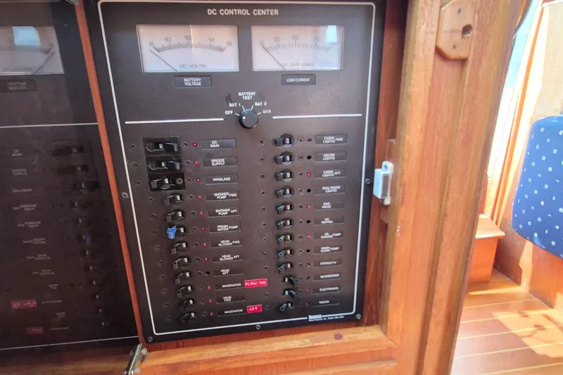 Slide: The Image of DC control panel on a 1990 Sabreline 36 Fast Trawler, featuring various switches and gauges. - 42