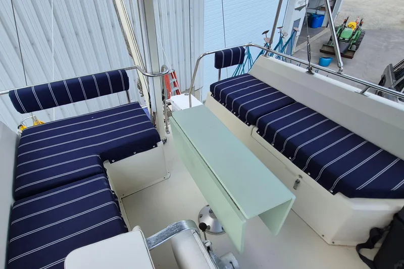 Slide: The Image of Interior seating of 1990 Sabreline 36 Fast Trawler with striped cushions. - 56
