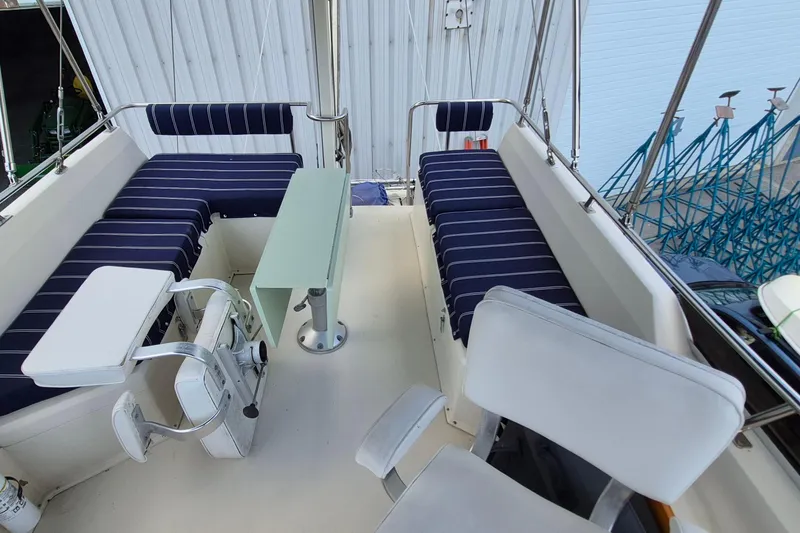 Slide: The Image of Interior of 1990 Sabreline 36 Fast Trawler with striped seating and helm station. - 57