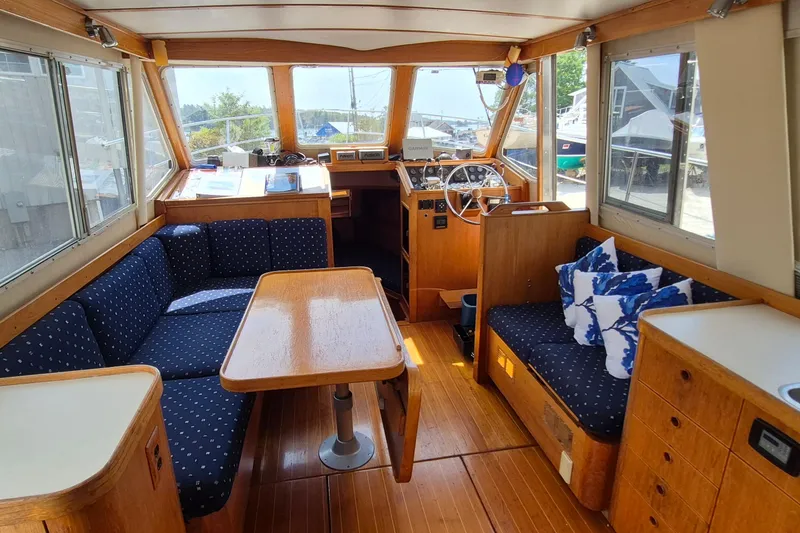 Slide: The Image of Interior of 1990 Sabreline 36 Fast Trawler with wood finish and blue seating. - 6