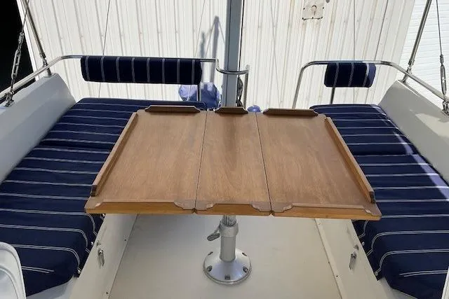 Slide: The Image of 1990 Sabreline 36 Fast Trawler interior with wooden table and striped seating. - 62