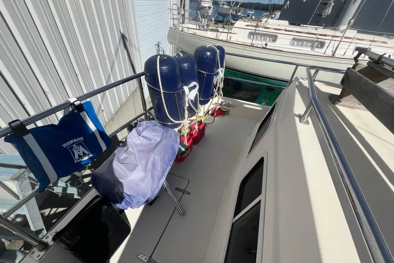 Slide: The Image of 1990 Sabreline 36 Fast Trawler deck with propane tank and safety equipment. - 69