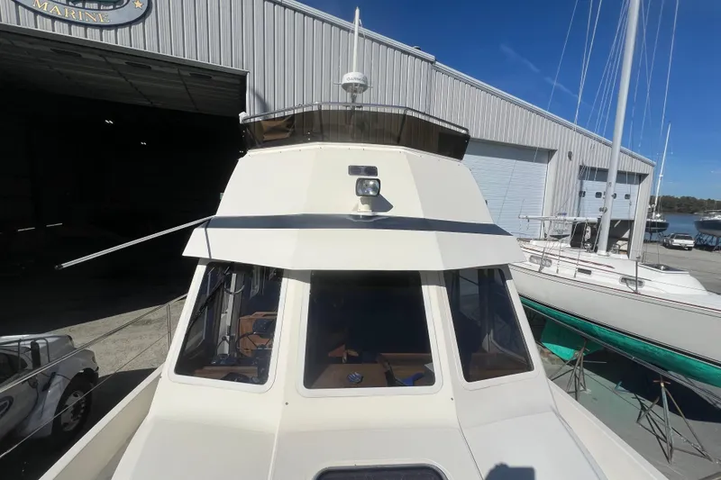 Slide: The Image of 1990 Sabreline 36 Fast Trawler docked near a marine workshop. - 72