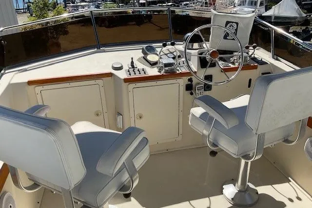 Slide: The Image of 1990 Sabreline 36 Fast Trawler helm with dual seats and steering wheel. - 73