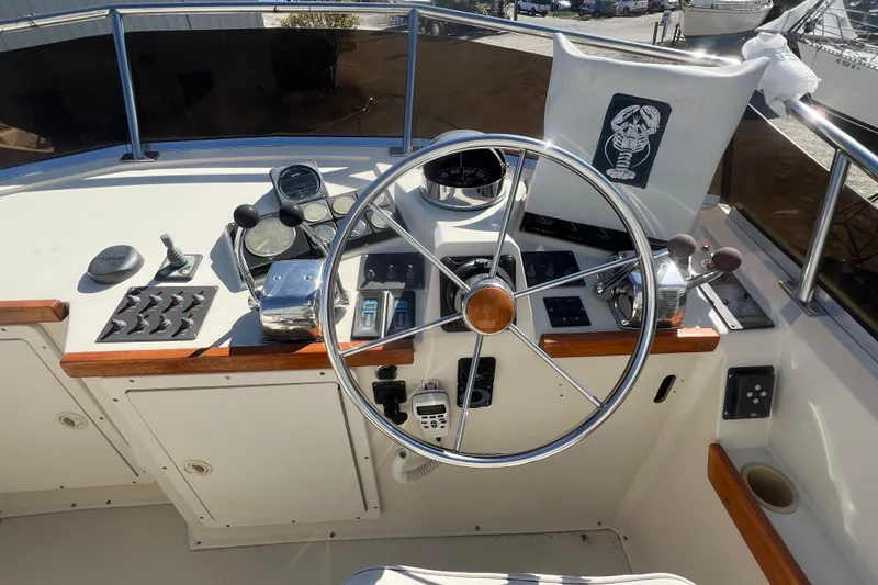 Slide: The Image of 1990 Sabreline 36 Fast Trawler helm with steering wheel and control panel. - 75