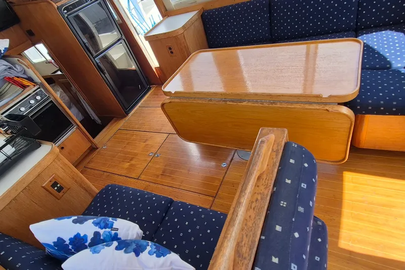 Slide: The Image of Interior of 1990 Sabreline 36 Fast Trawler with wooden flooring and cozy seating area. - 8