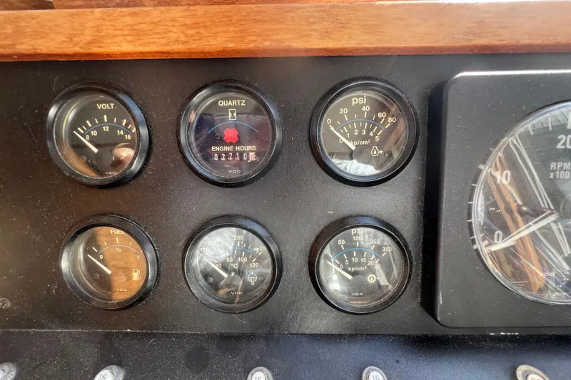 Slide: The Image of Dashboard gauges of a 1990 Sabreline 36 Fast Trawler, displaying volt, engine hours, and PSI. - 80