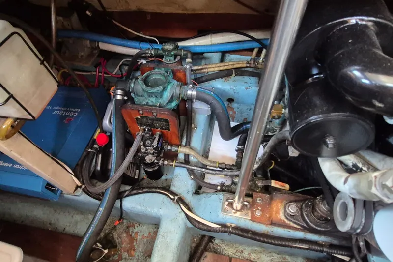 Slide: The Image of Engine compartment of a 1990 Sabreline 36 Fast Trawler, showcasing mechanical components and wiring. - 81