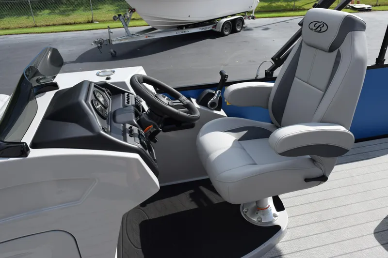Slide: The Image of 2026 Bentley Pontoons Legacy 243 Swingback helm with luxurious captain's chair and control panel. - 11