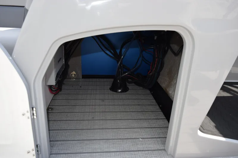 Slide: The Image of Interior view of 2026 Bentley Pontoons Legacy 243 Swingback, showcasing wiring and storage area. - 17