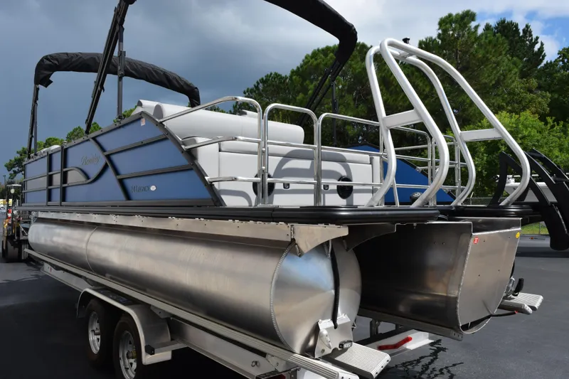Slide: The Image of 2026 Bentley Pontoons Legacy 243 Swingback on trailer, showcasing sleek design and modern features. - 6
