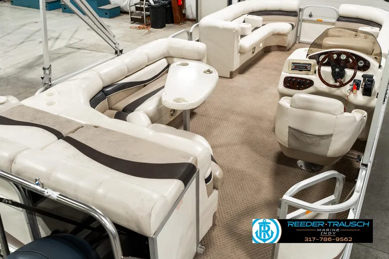 Slide: The Image of 2003 Bennington 2050 RL boat interior with plush seating and steering console. - 14
