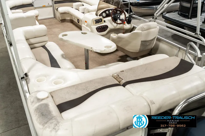 Slide: The Image of Interior of 2003 Bennington 2050 RL boat with beige seating and table. - 15