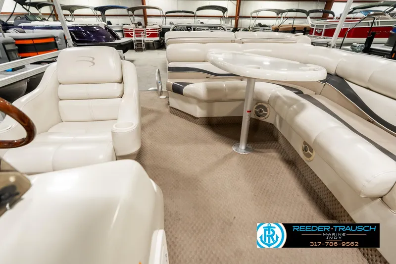 Slide: The Image of Interior of 2003 Bennington 2050 RL boat with plush seating and table in showroom. - 17