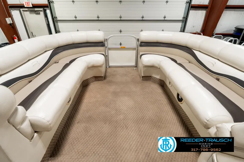 Slide: The Image of Interior of 2003 Bennington 2050 RL pontoon boat with white seating and cup holders. - 21