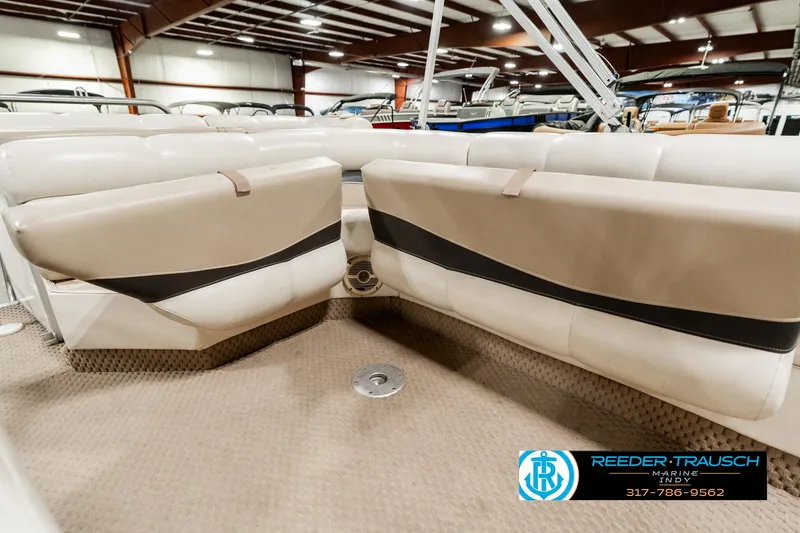 Slide: The Image of 2003 Bennington 2050 RL pontoon boat interior with beige seating in showroom. - 28