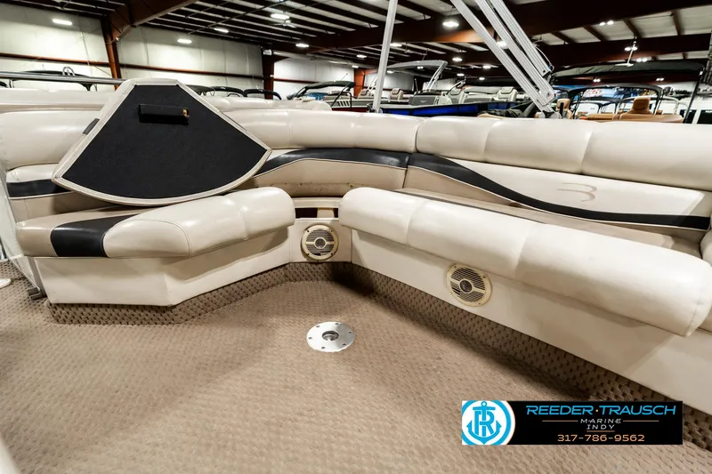 Slide: The Image of 2003 Bennington 2050 RL boat interior with beige seating in showroom. - 29