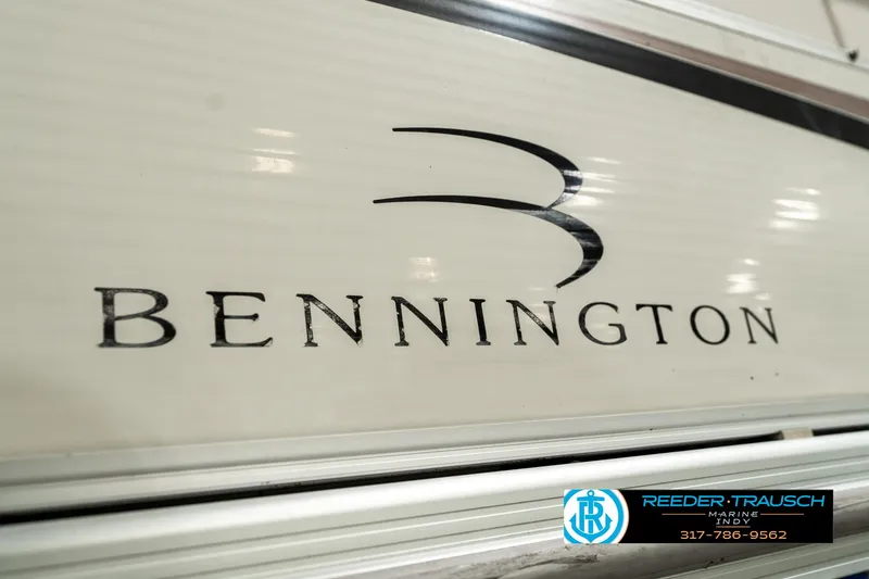 Slide: The Image of 2003 Bennington 2050 RL boat seating with cup holders, featuring white and gray upholstery. - 45