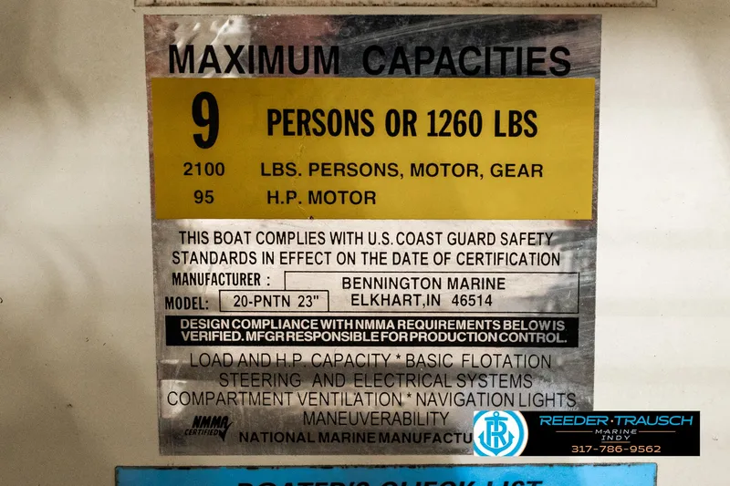 Slide: The Image of 2003 Bennington 2050 RL boat interior with white and gray seating, cup holder, and carpeted floor. - 47