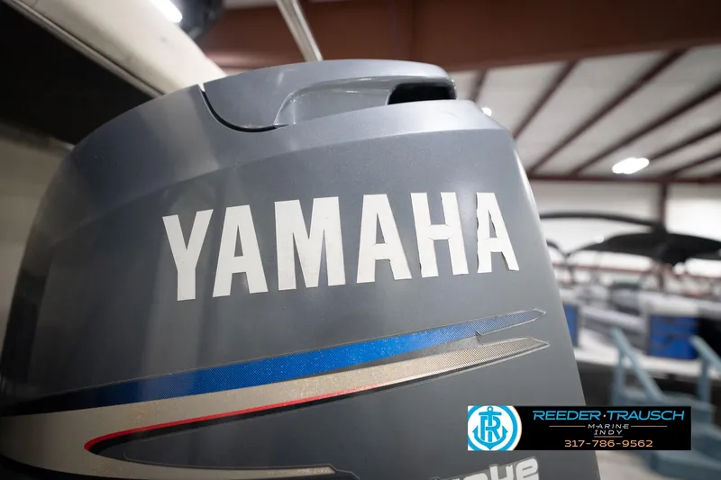 Slide: The Image of Yamaha outboard motor on a 2003 Bennington 2050 RL boat in a showroom. - 50