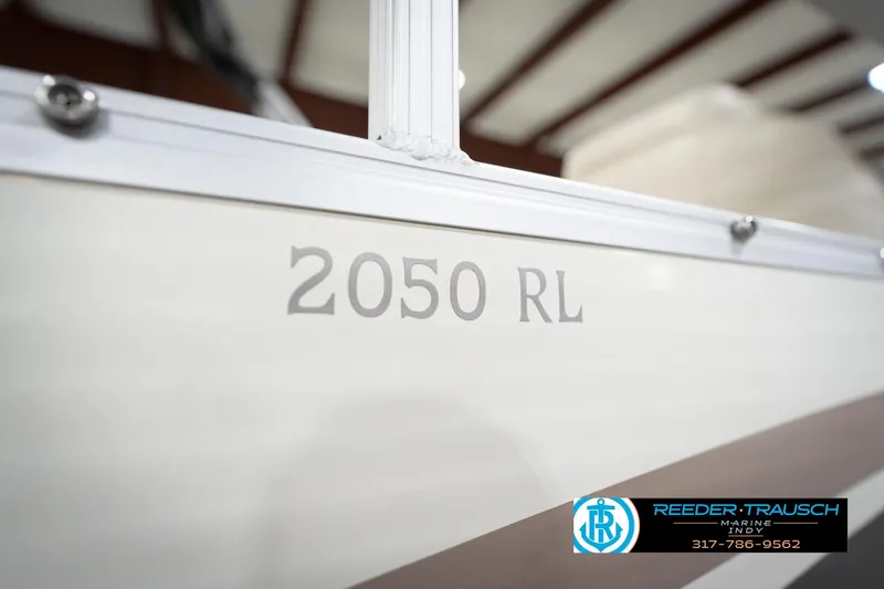 Slide: The Image of 2003 Bennington 2050 RL boat detail with Reeder-Trausch Marine contact information. - 54
