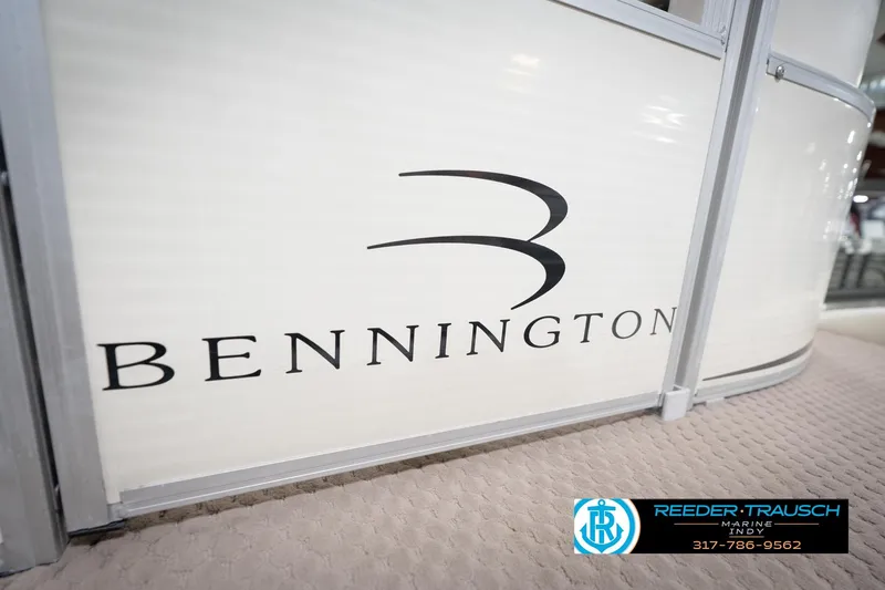 Slide: The Image of Bennington 2050 RL 2003 boat logo on white surface, Reeder-Trausch Marine contact info. - 55