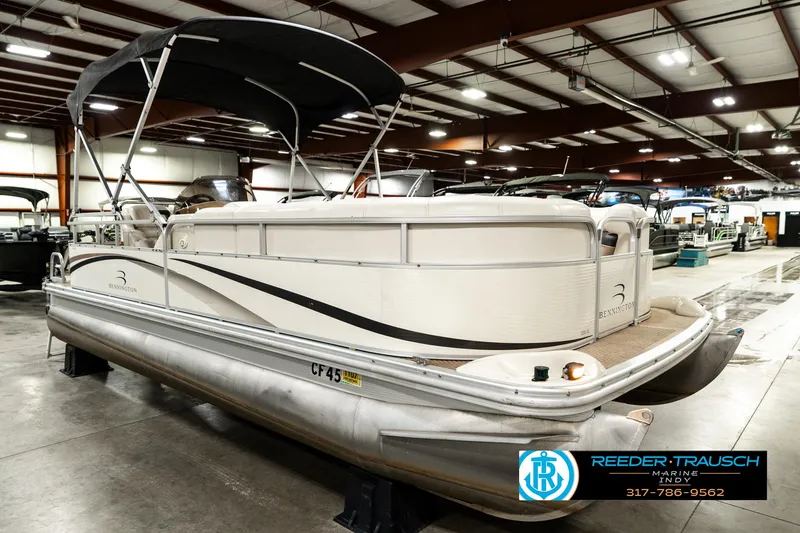 Slide: The Image of 2003 Bennington 2050 RL pontoon boat on trailer in indoor showroom. - 6