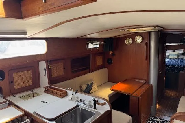 Slide: The Image of Interior of a 1982 Morgan 383 sailboat, featuring a cozy cabin with wood accents. - 10