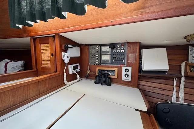 Slide: The Image of Interior of 1982 Morgan 383 sailboat with navigation equipment and wooden cabinetry. - 12