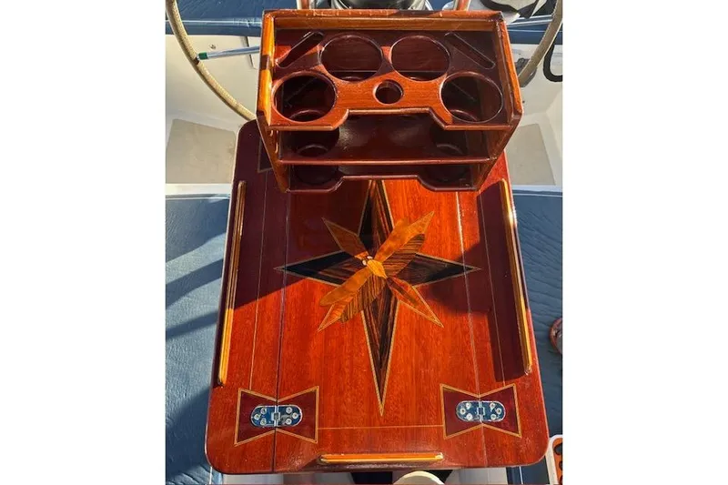 Slide: The Image of Wooden table with intricate star inlay on a 1982 Morgan 383 boat. - 17