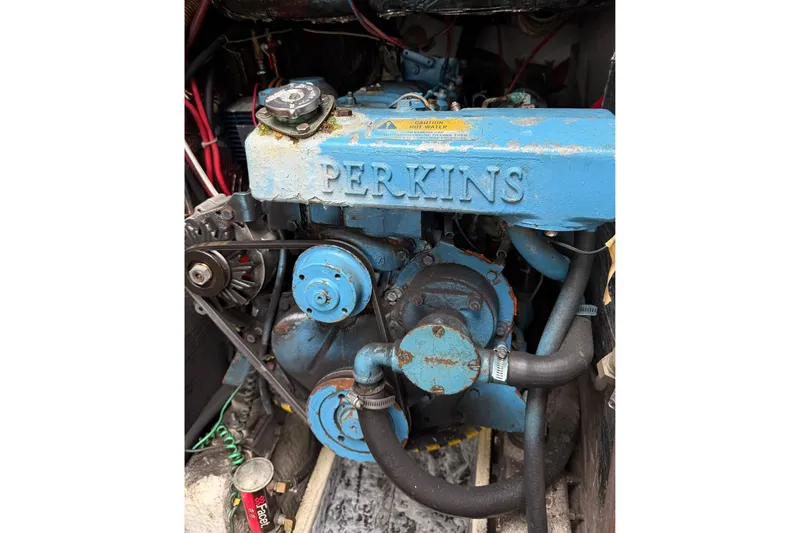 Slide: The Image of 1982 Morgan 383 with Perkins engine, showcasing vintage blue machinery and components. - 22