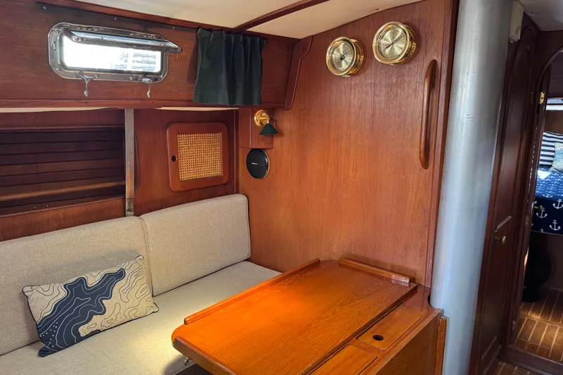 Slide: The Image of Interior of 1982 Morgan 383 sailboat with wooden furnishings and nautical decor. - 26