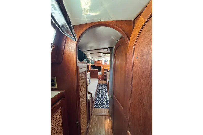 Slide: The Image of Interior of 1982 Morgan 383 sailboat with wooden paneling and patterned carpet. - 27