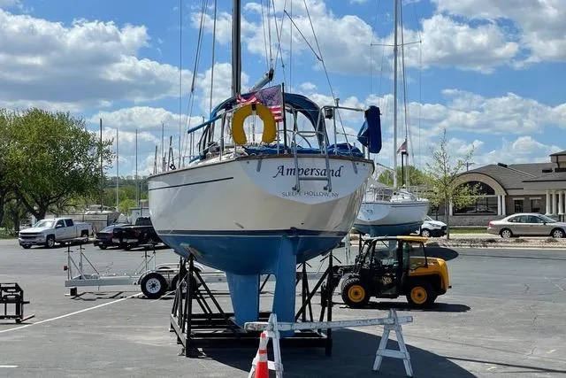 Slide: The Image of 1982 Morgan 383 sailboat named "Ampersand" on a trailer in a marina parking lot. - 4
