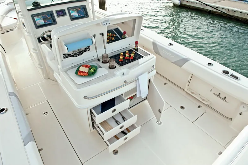 Slide: The Image of 2015 Boston Whaler 320 Outrage boat interior with open storage and food preparation area. - 38