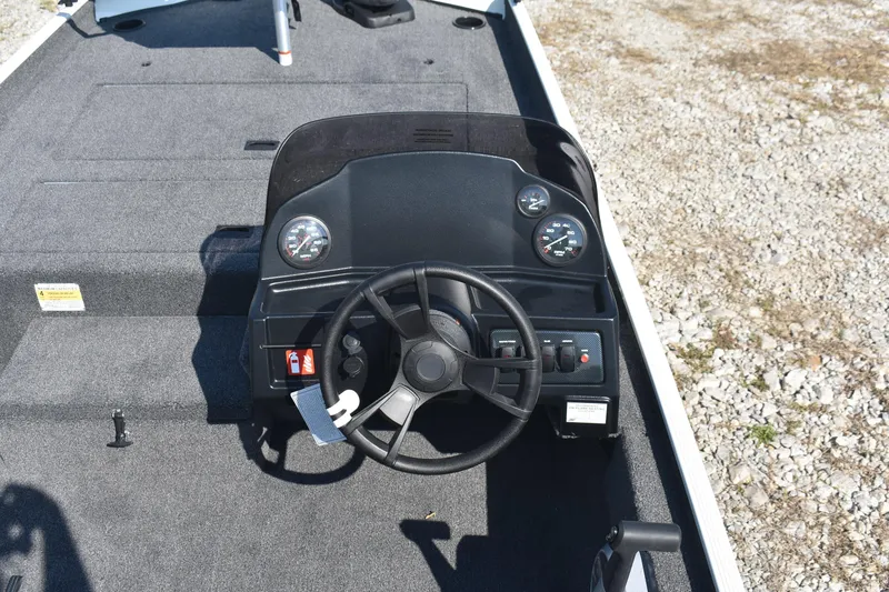 Slide: The Image of 2026 Lowe Skorpion 17 boat dashboard with steering wheel and gauges. - 10