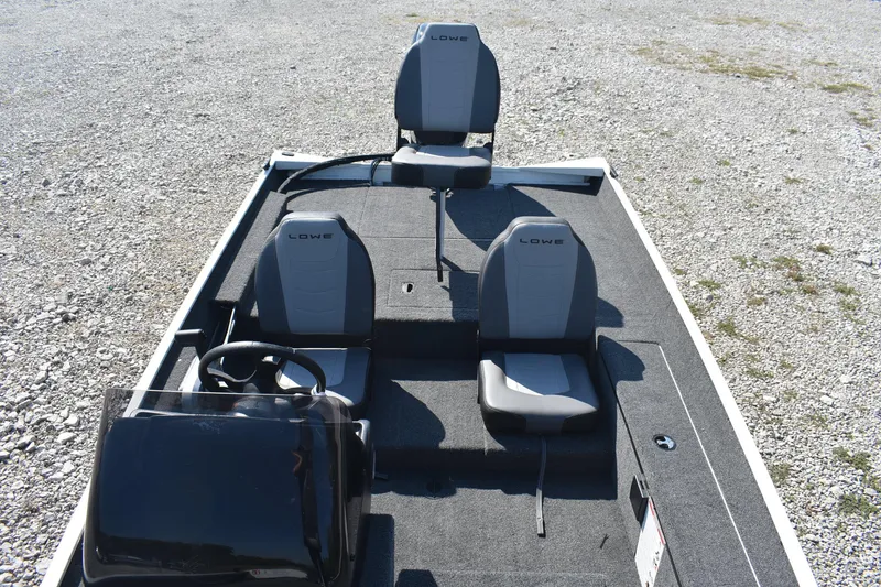 Slide: The Image of 2026 Lowe Skorpion 17 boat interior with three seats and steering console. - 11