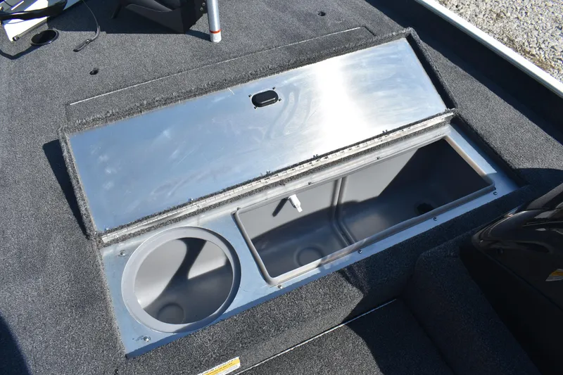 Slide: The Image of Open storage compartment on 2026 Lowe Skorpion 17 boat, featuring carpeted interior. - 16