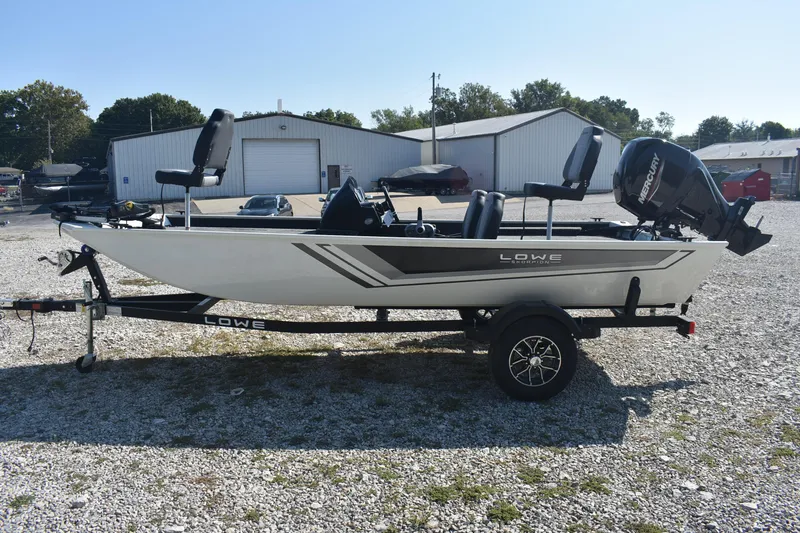 Slide: The Image of 2026 Lowe Skorpion 17 fishing boat on trailer, parked outdoors. - 5