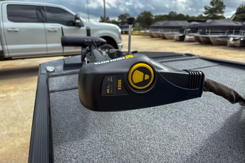 Slide: The Image of 2024 Bass Tracker Classic XL with Minn Kota Edge trolling motor, parked near a truck. - 4