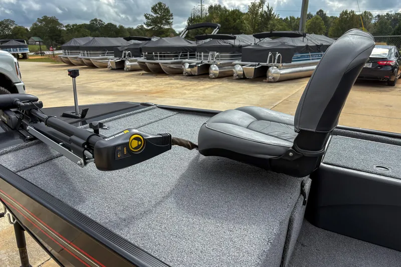 Slide: The Image of 2024 Bass Tracker Classic XL boat with trolling motor and cushioned seat on deck. - 5