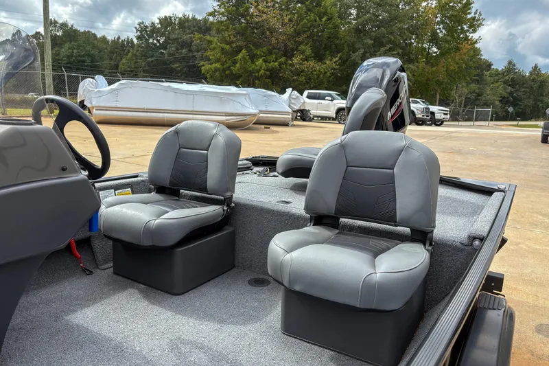 Slide: The Image of 2024 Bass Tracker Classic XL boat interior with two gray seats and steering wheel. - 7