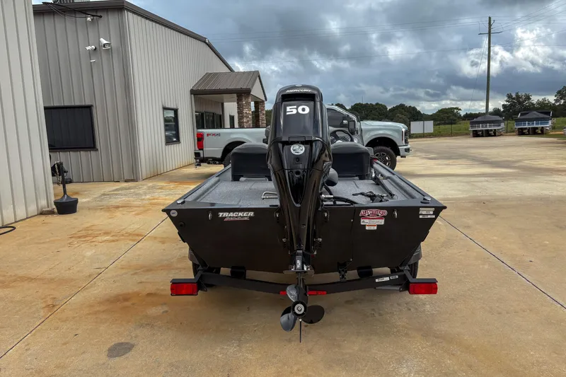 Slide: The Image of 2024 Bass Tracker Classic XL boat with Mercury 50 engine, parked outdoors. - 9