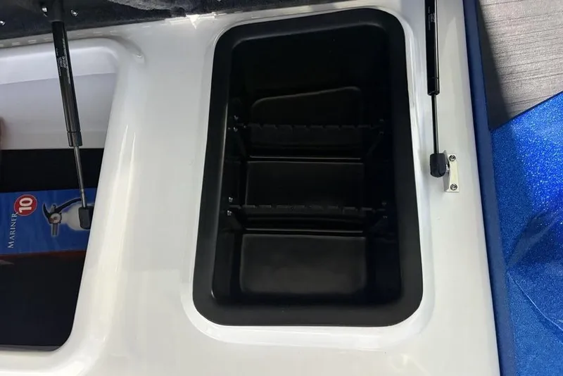 Slide: The Image of Storage compartment of 2026 Skeeter ZXR19 SE boat, featuring hydraulic lift support. - 12