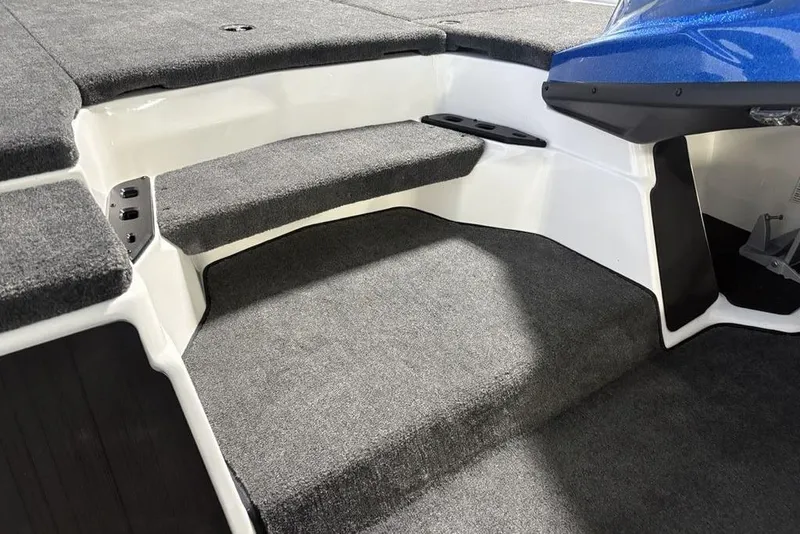Slide: The Image of Interior of 2026 Skeeter ZXR19 SE boat with carpeted steps and seating area. - 15