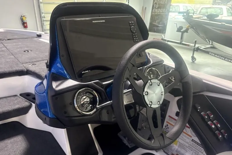 Slide: The Image of Steering console of 2026 Skeeter ZXR19 SE boat with modern controls and display. - 16