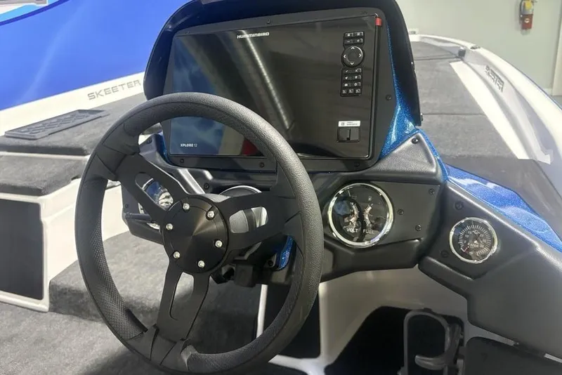 Slide: The Image of Steering console of 2026 Skeeter ZXR19 SE boat with digital display and gauges. - 21