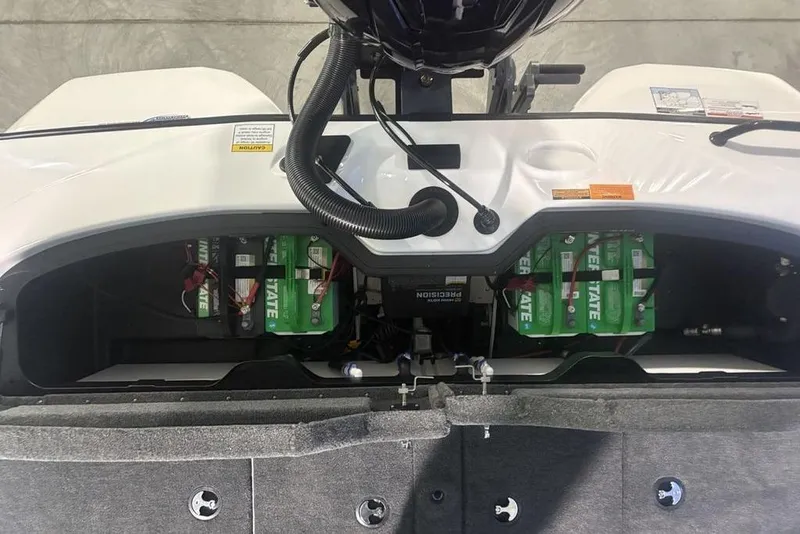 Slide: The Image of Battery compartment of 2026 Skeeter ZXR19 SE boat, showcasing multiple green batteries. - 29
