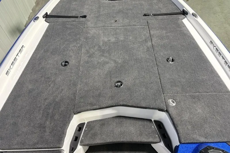 Slide: The Image of 2026 Skeeter ZXR19 SE boat deck with gray carpet and storage compartments. - 9